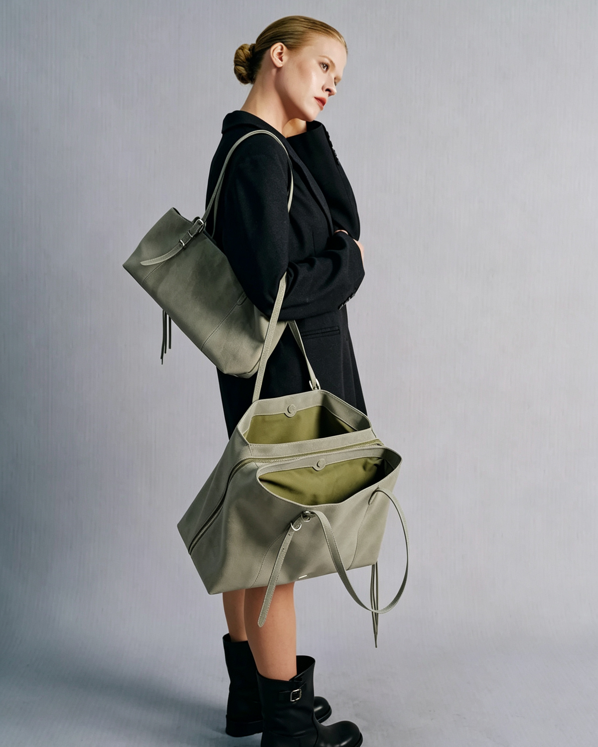 Model carrying the gray Mercer leather work tote