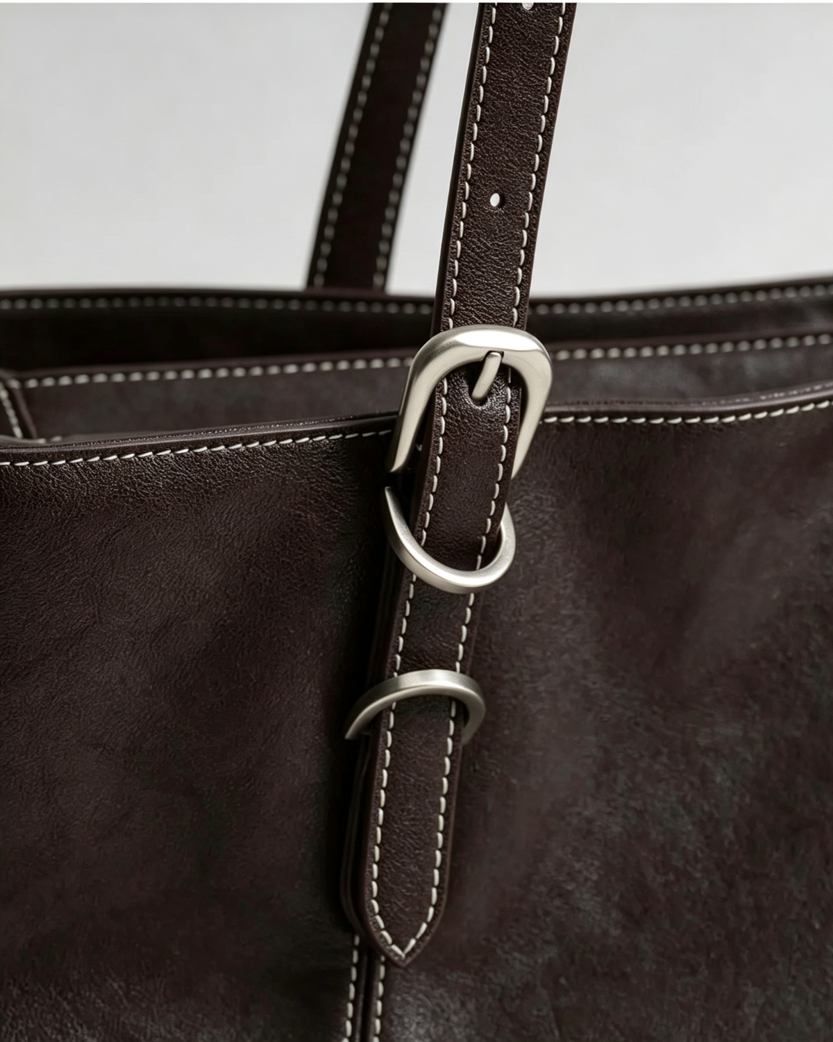 Adjustable shoulder strap buckle on the Mercer leather work tote