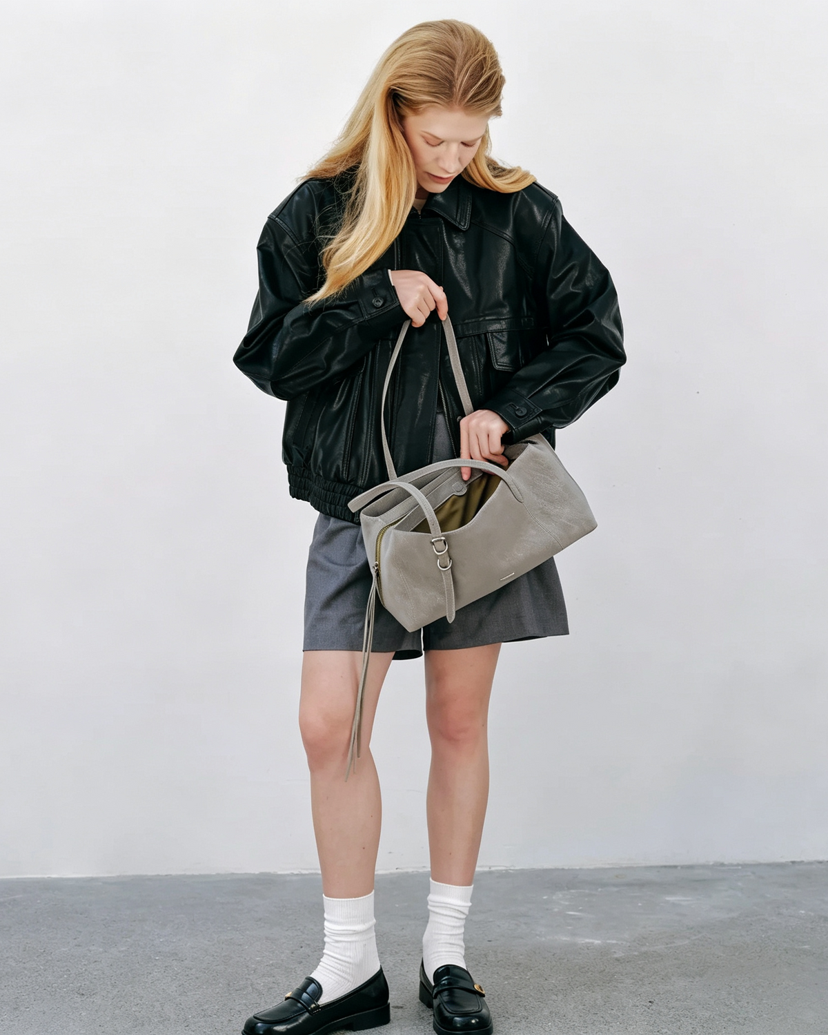 Model carrying the gray Mercer leather work tote